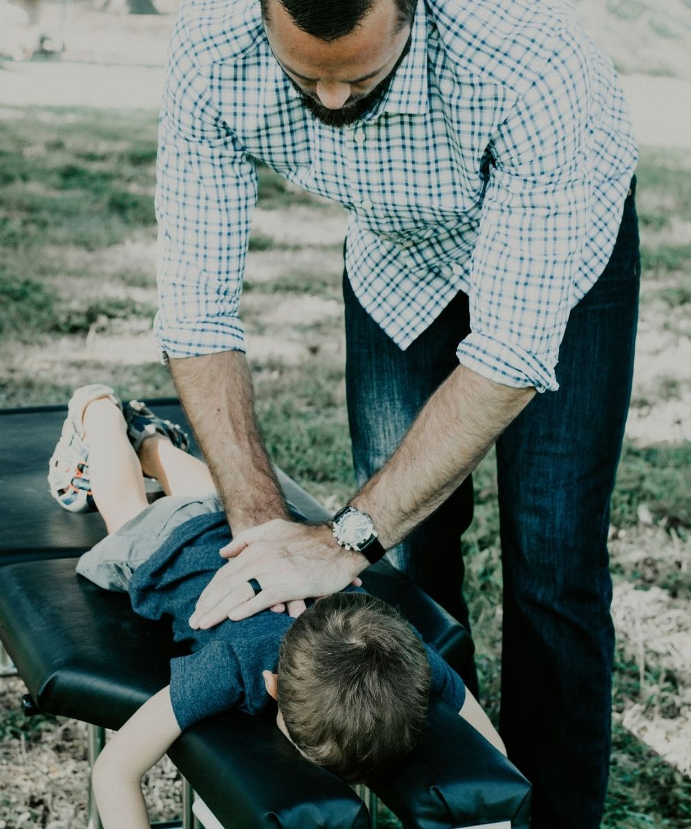 Young boy getting a chiropractic adjustment